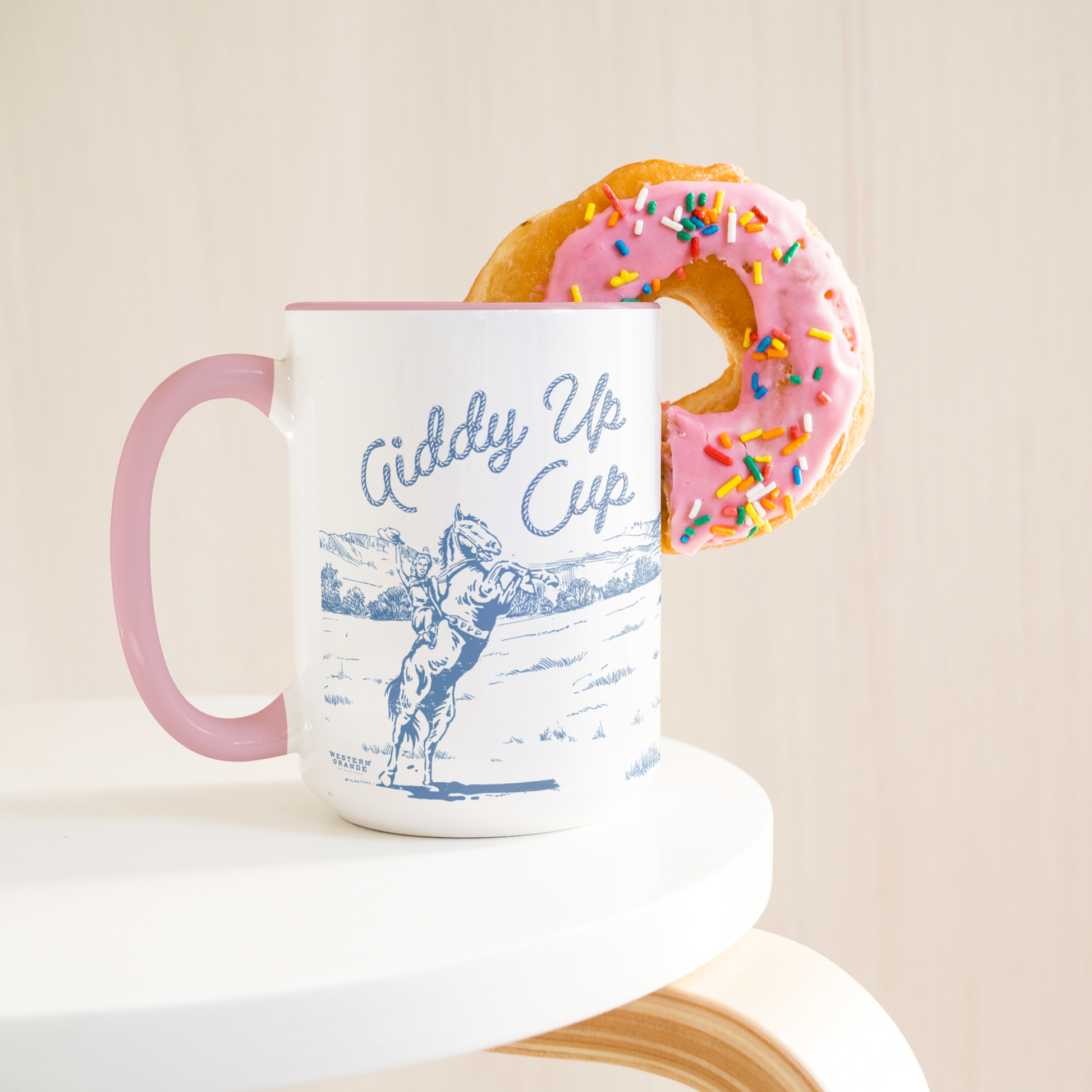 GIDDY_UP_CUP_-PINK_MUG__BLUE_ART-_15oz_Lifestyle_Donut_LH_Mockup.png_15383363